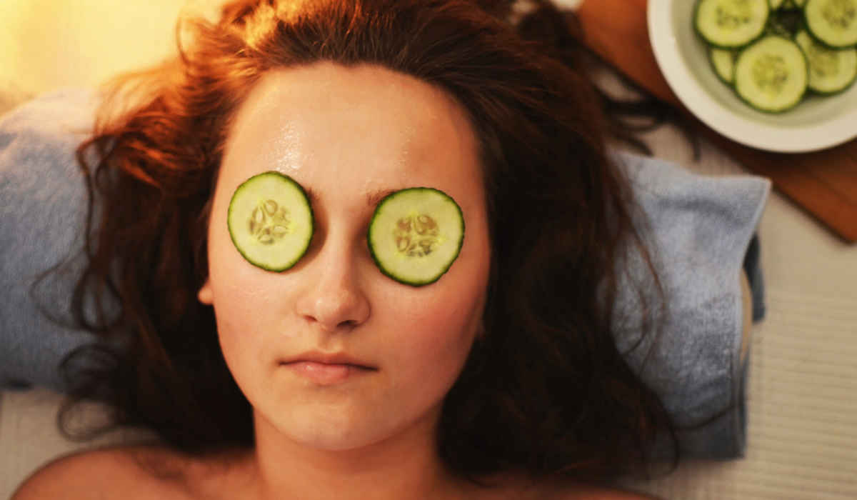 Woman relaxing with cucumbers over her eyes.